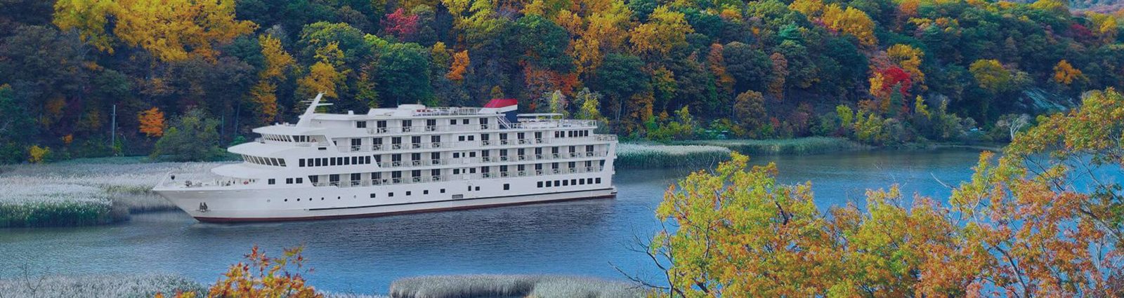 American Cruise Lines riverboat among autumn trees